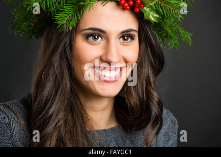 Portrait of a beautiful woman with Cristmas decorations on the head Stock Photo