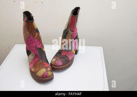 A pair of 1970s patchwork men's platform soled boots that ran in the wash Stock Photo