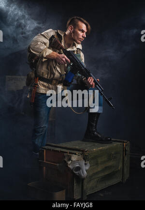 Armed man with a gun. Post-apocalyptic fiction. Stalker. Stock Photo