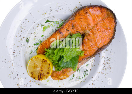 Grilled salmon steak with spinach in white plate, top view Stock Photo