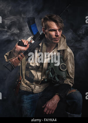 Armed man with a gun. Post-apocalyptic fiction. Stalker. Stock Photo