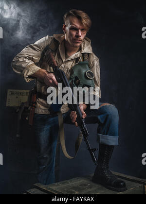 Armed man with a gun. Post-apocalyptic fiction. Stalker. Stock Photo