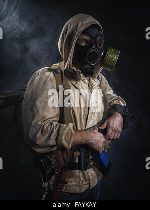 Armed man in protective mask. Stalker. Post-apocalyptic fiction Stock Photo