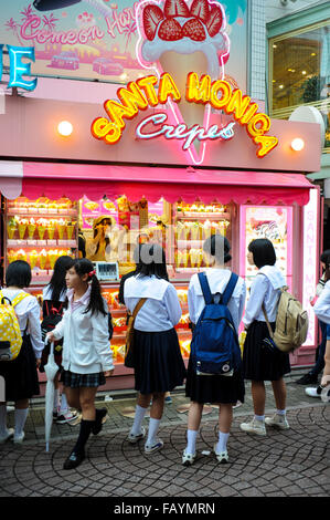Japanese girls in front of a crepes shop in Takeshita street in Harjuku Tokyo Japan Stock Photo