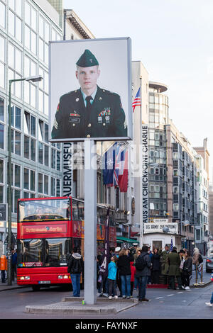 BERLIN, GERMANY - OCTOBER 31, 2015 : Tourists visiting Checkpoint Charlie in Berlin, Germany. Stock Photo