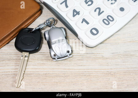 Car key with calculator and wallet on wood table Stock Photo
