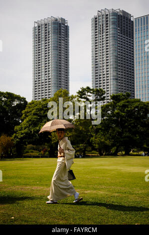 Japanese woman with kimono and umbrella in Hama Rikyu Gardens Tokyo Japan Stock Photo