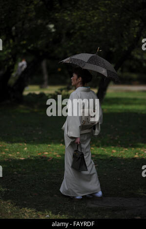 Japanese woman with traditional kimono in Hama Rikyu Gardens, Tokyo, Japan Stock Photo