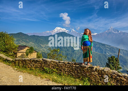 Nepalese woman in front of her home in the Himalayas mountains near Pokhara Stock Photo