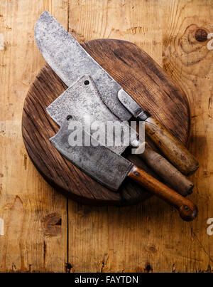 Butcher Meat cleavers large chef's knives on Chopping board block on wooden background Stock Photo