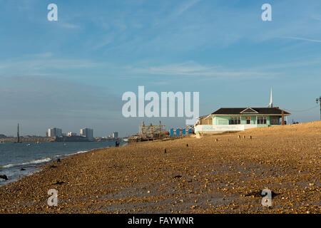 Cafe on a cold windswept day out of season in Southsea. Looking down the beach towards the harbour entrance Stock Photo