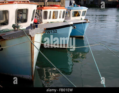 Three small fishing trawlers moored in Padstow Harbour, Cornwall, UK Stock Photo