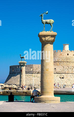 Mandraki harbour and fortress Agios Nicolaos in Rhodes town, Rhodes Island, Greece, UNESCO Stock Photo