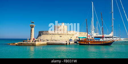 Mandraki harbour and fortress Agios Nicolaos in Rhodes town, Rhodes Island, Greece, UNESCO Stock Photo