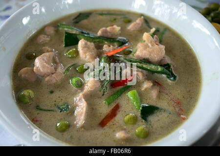 Tipycal dish from Bangkok, Thailand. Green curry chicken in coconut milk. Khang Keaw Wan Gai. Amita Thai Cooking School. Bangkok. At Amita Thai Cooking Class, you will learn how to prepare and cook many favorite Thai dishes from our extensive list of recipes such as Khang Keaw Wan Gai (Green Curry Chicken in Coconut Milk), Phad Thai (Stir fried soft rice noodles with prawns and tamarind sauce) and Tom Yum Goong (Clear hot and sour soup with fresh prawns). Stock Photo