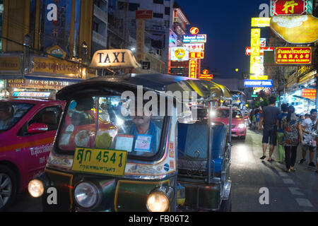 Tuk tuks and taxis in the street. View down Thanon Yaowarat road at night in central Chinatown district of Bangkok Thailand. Yao Stock Photo