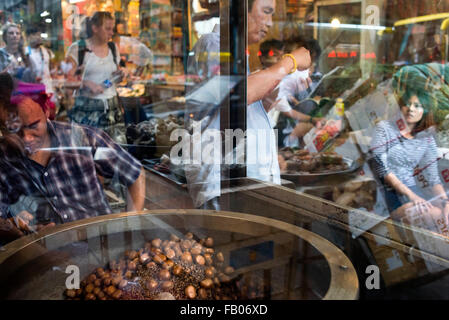 Roast chestnuts , Bangkok's Chinatown , Thailand. Market stall and street food being prepared in Chinatown Bangkok, Thailand. Ya Stock Photo