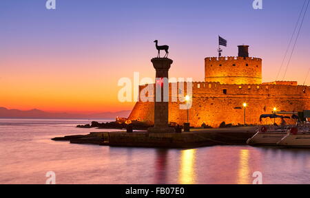 Mandraki harbour and fortress Agios Nicolaos before sunrise, Rhodes town, Rhodes Island, Greece, UNESCO Stock Photo