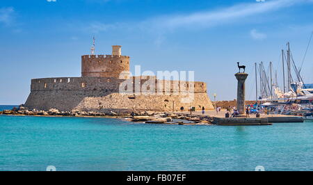 Mandraki harbour and fortress Agios Nicolaos in Rhodes town, Rhodes Island, Greece, UNESCO Stock Photo