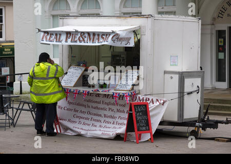 A man in a high-vis jacket ordering food at a Real Pie and Mash Company stand outside the Willis Museum in Basingstoke Stock Photo