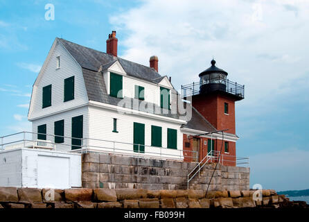 The tower of Rockland Breakwater lighthouse in midcoast Maine is made of brick. The lighthouse is located at the end of a nearly mile long breakwater. Stock Photo