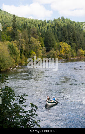Fly fishermen fishing on a boat in the McKenzie River near the Goodpasture Bridge in Vida, Oregon. Stock Photo