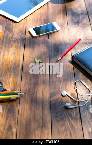 Vertical composition of art items on wooden desk Stock Photo