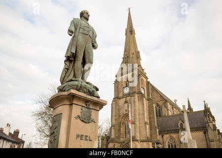 The Peel Memorial statue , Bury , with St Mary's Parish Church, Bury to the right Stock Photo