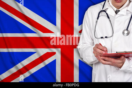 Doctor with clipboard on a United Kingdom flag on background Stock Photo
