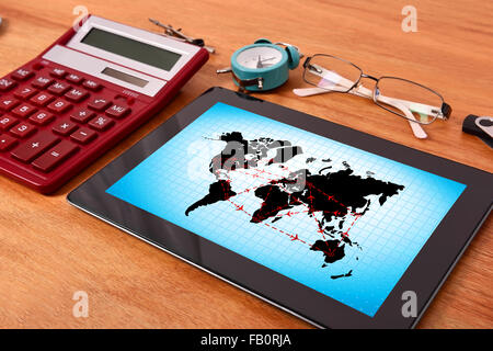 Tablet pc with scheme of international flights on table Stock Photo