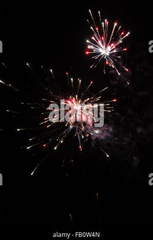 Cluster of colourful fireworks against dark sky Stock Photo