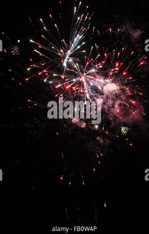 Cluster of colourful fireworks against dark sky Stock Photo