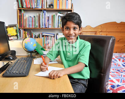 Young boy doing his homework after school Stock Photo
