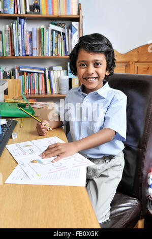 Young boy doing his homework after school Stock Photo