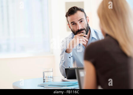 Man and woman sitting in office Stock Photo