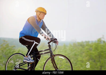 Mature man riding bicycle Stock Photo