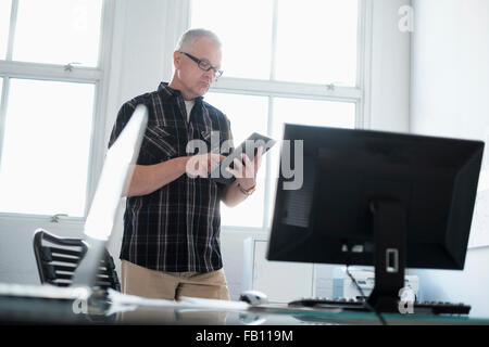 Man in office using digital tablet