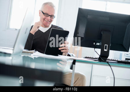 Man in office using tablet Stock Photo