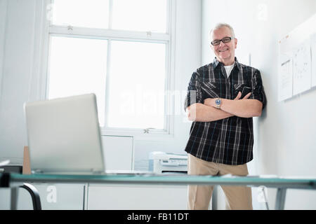 Portrait of smiling man in modern office Stock Photo