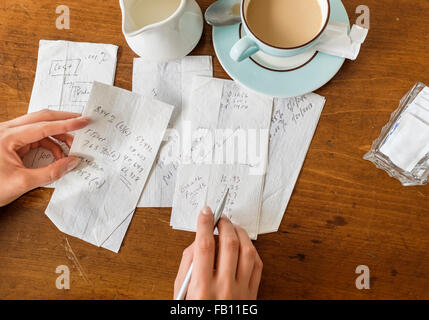 Woman writing on napkins Stock Photo