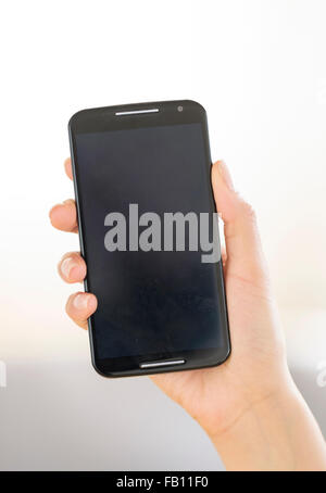 Hand holding smart phone Stock Photo
