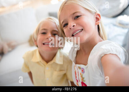 Girl (6-7) and boy (4-5) looking at camera Stock Photo