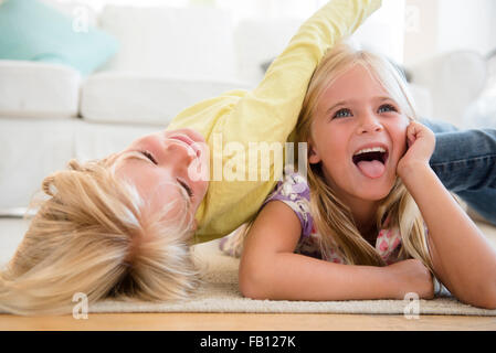 Boy (4-5) and girl (6-7) playing on floor Stock Photo