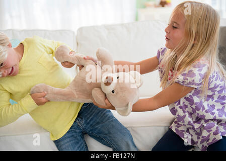 Boy (4-5) and girl (6-7) arguing Stock Photo