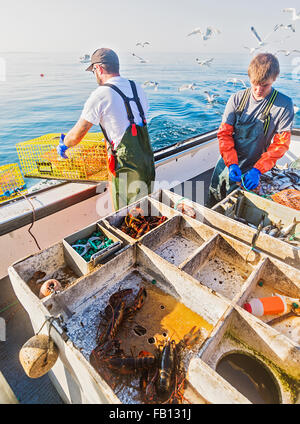 Fishermen working on boat Stock Photo