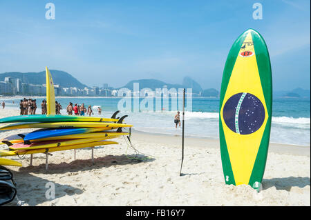 RIO DE JANEIRO, BRAZIL - NOVEMBER 10, 2015: Brazilian flag surfboard stands in front of a lifeguard training course Copacabana. Stock Photo