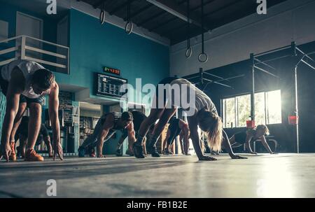 Surface level view of people exercising together in gym