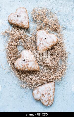 Overhead view of heart shaped gingerbread biscuits on straw Stock Photo