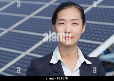 Businesswoman on roof of solar panel assembly factory, Solar Valley, Dezhou, China Stock Photo