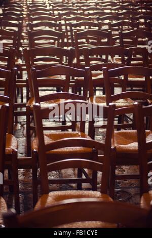 Rows of traditional wooden chairs Stock Photo